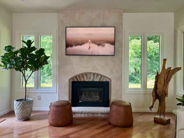Modern living room featuring a handcrafted decorative stucco fireplace feature wall completed by GreenTech Painting in London, Ontario.