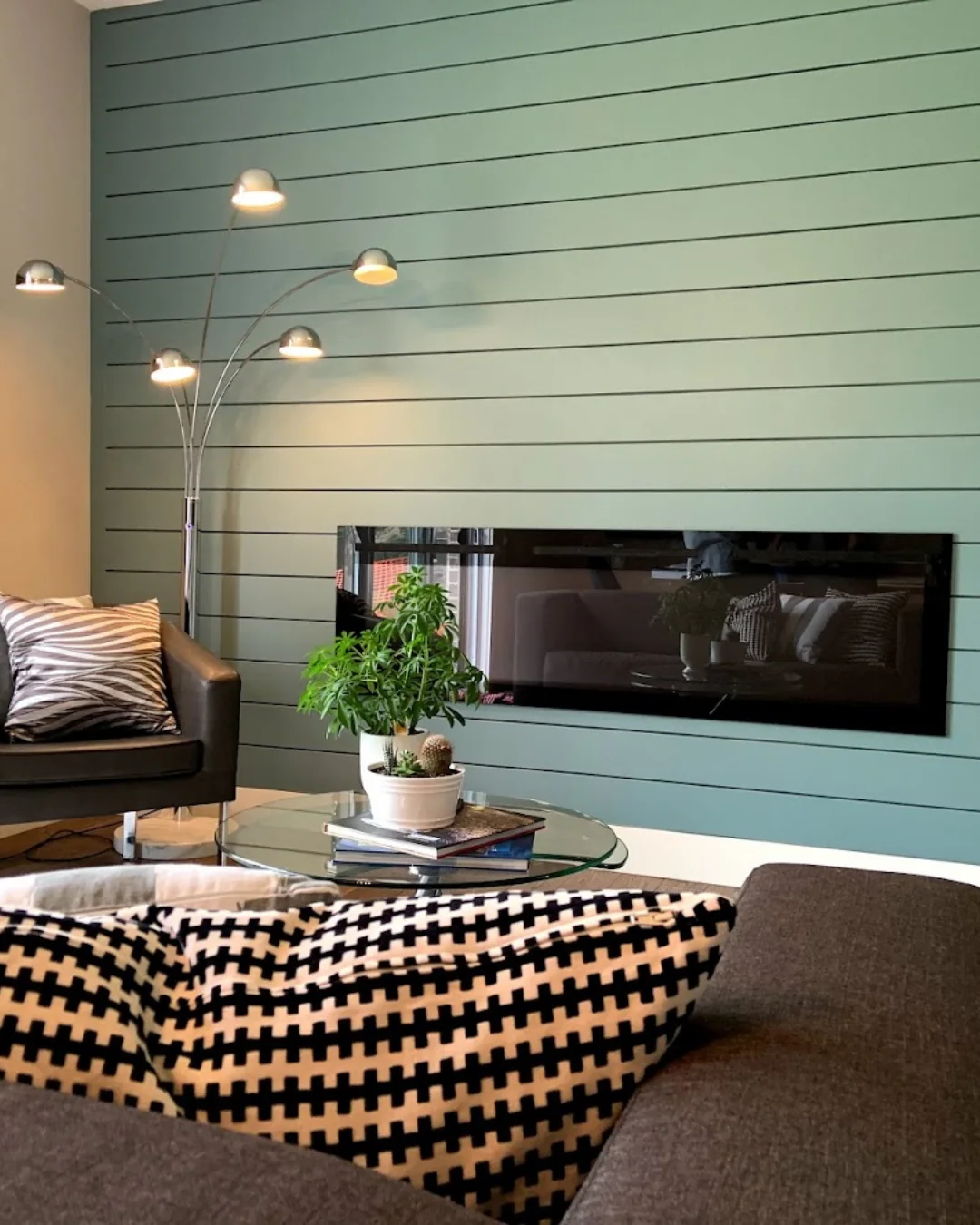 Professionally painted green accent wall with horizontal architectural detailing in a modern living room by GreenTech Painting in London, Ontario.