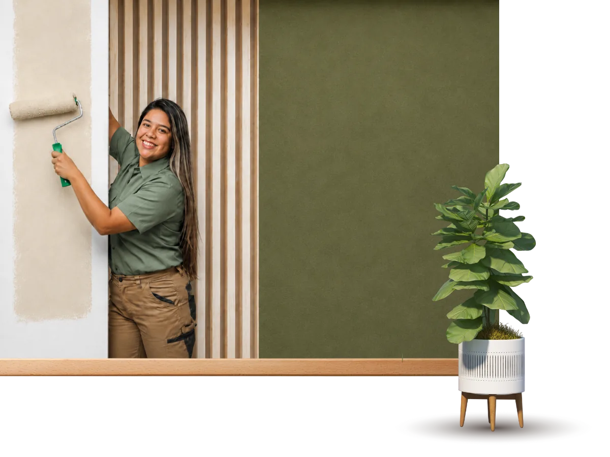 GreenTech Painting professional painting an interior accent wall with a roller in London, Ontario.