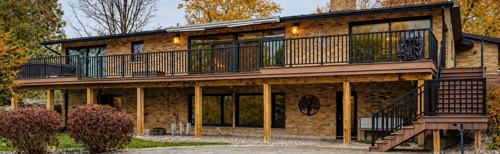 Professionally painted residential exterior with wood and brick finishes by GreenTech Painting in London, Ontario.