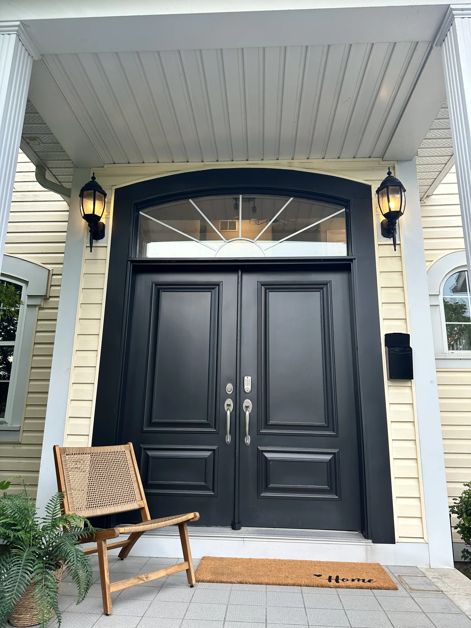 Professionally painted black front entry door with white trim by GreenTech Painting in London, Ontario.