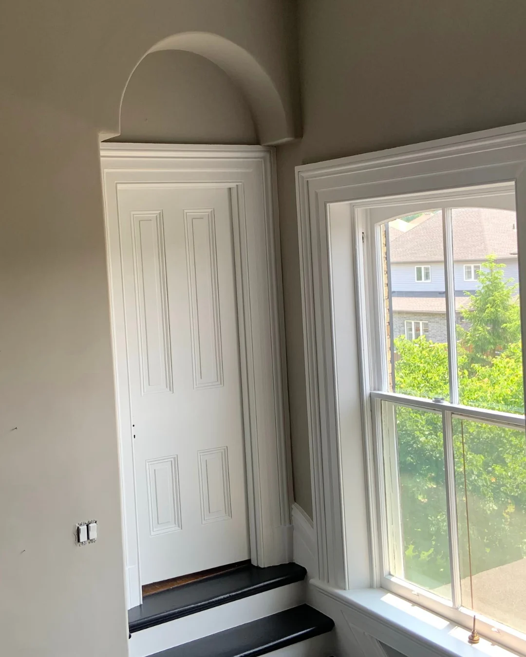 Plaster repair around original window trim and architectural details in a heritage home in London, Ontario.